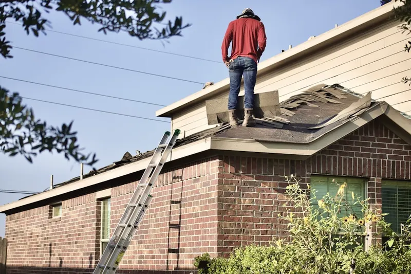 Professional roofer working on a residential roof in Cooksville